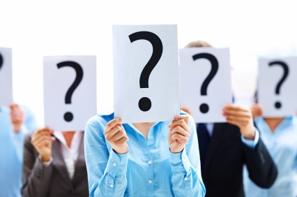 picture of students holding a sheet of paper with a question mark on it