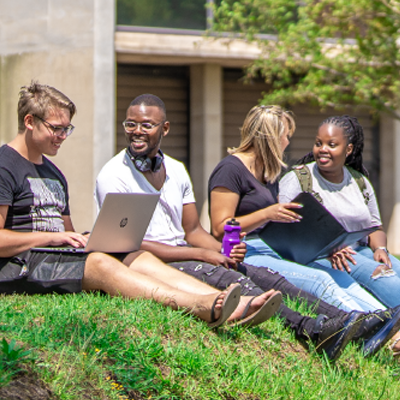 Students laughing and working on a laptop