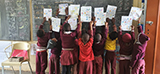 Proud Grade R and Grade 1 learners show off their work at one of the weekly sessions at Ourief Primary School.