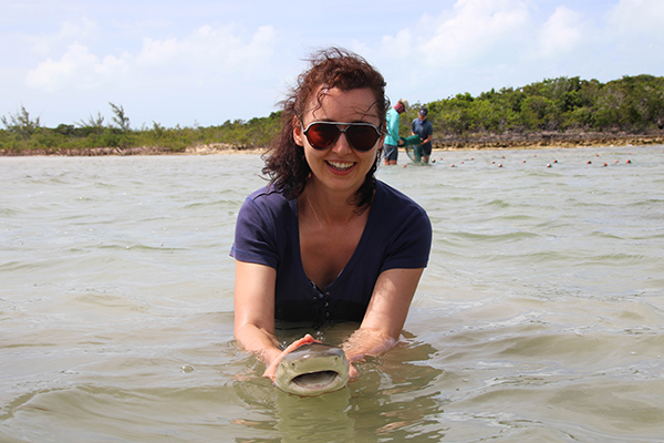 Dr Roksana Majewska holding a juvenile lemon shark.